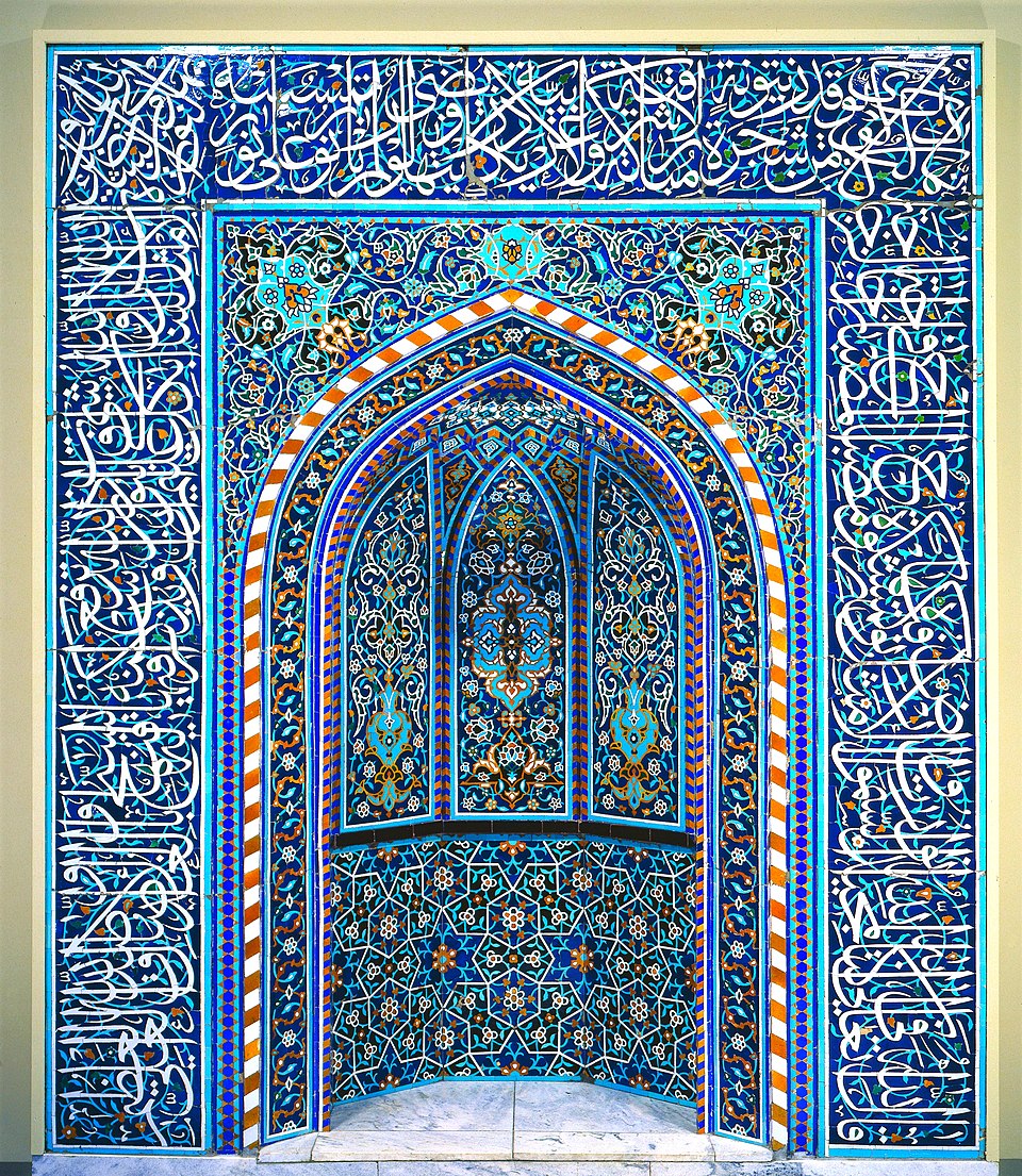 An Islamic tile mihrab from Isfahan, Iran, covered in intricate blue and turquoise geometric patterns