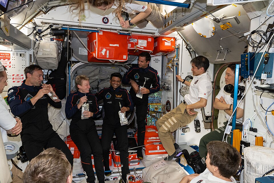 Astronauts floating inside the International Space Station working in microgravity