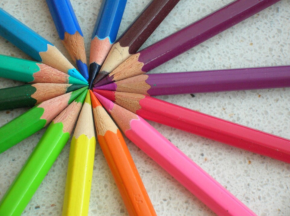 Colored pencils arranged in a rainbow circle showing many bright colors