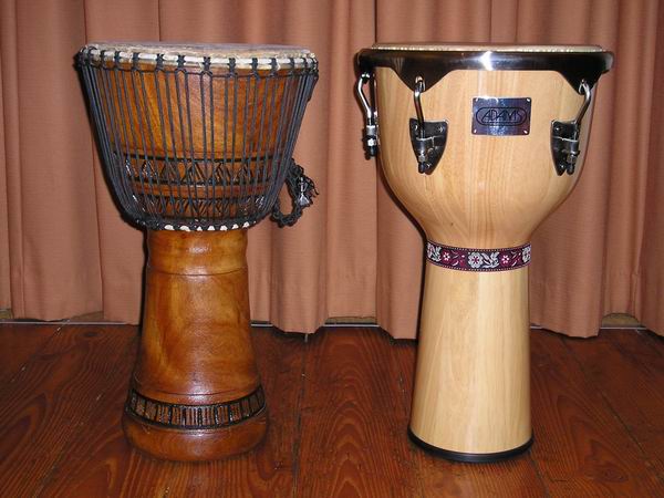 Two djembe drums, a traditional wooden one with rope tuning and a modern one