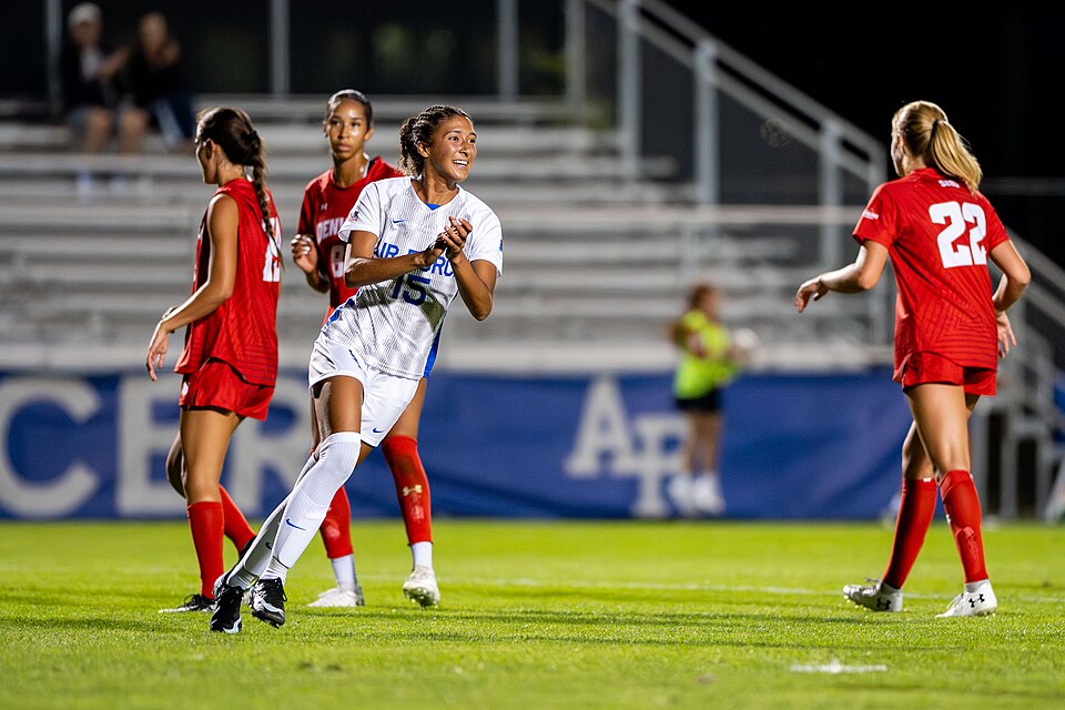 A soccer player celebrating after scoring a goal in a stadium