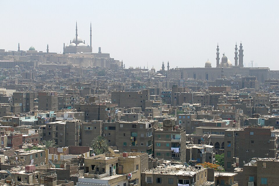 The Cairo cityscape with mosques and minarets on the hilltop in the background