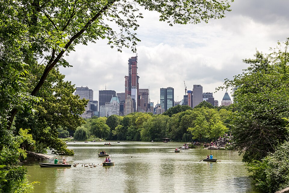 Central Park lake with boats and the Manhattan skyline in the background