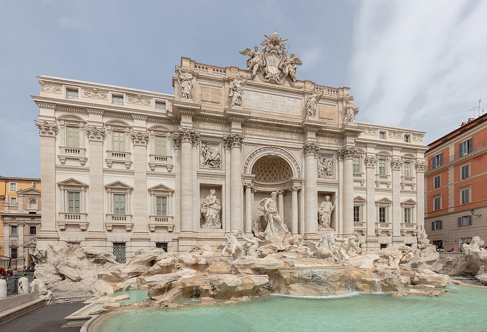 The Trevi Fountain in Rome with its statues and bright blue water