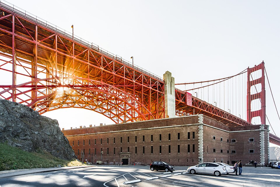 The Golden Gate Bridge at sunset with Fort Point in the foreground