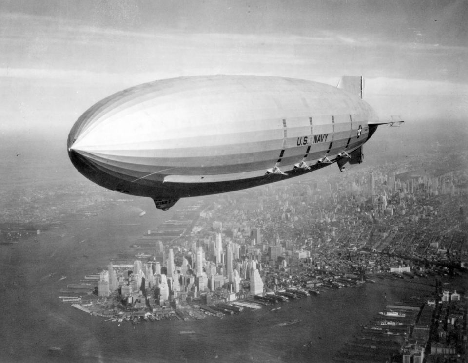 The USS Macon airship flying over a city in 1933