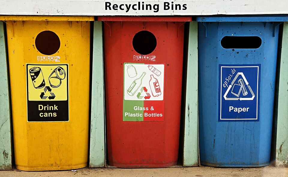 Colorful recycling bins for cans, glass, and paper