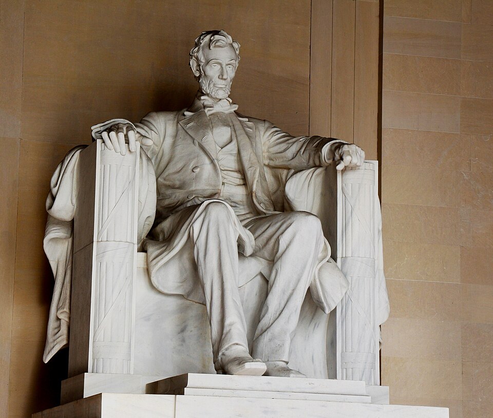 The statue of Abraham Lincoln sitting inside the Lincoln Memorial