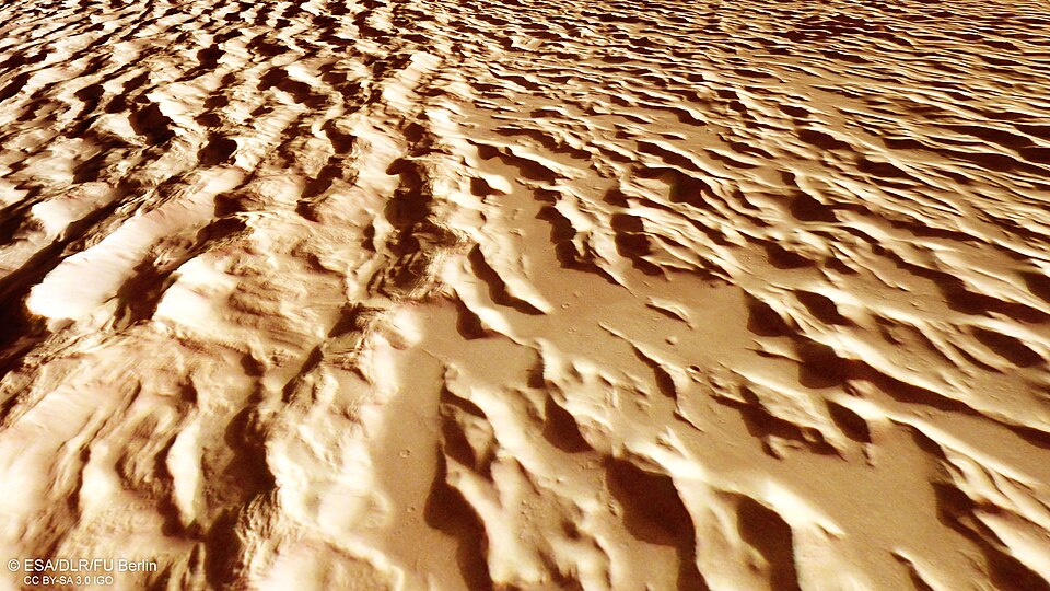 The wavy, ridged landscape of Mars near the giant volcano Olympus Mons