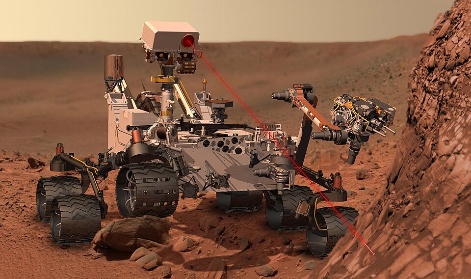 The Curiosity rover exploring the red surface of Mars and using its laser to study rocks